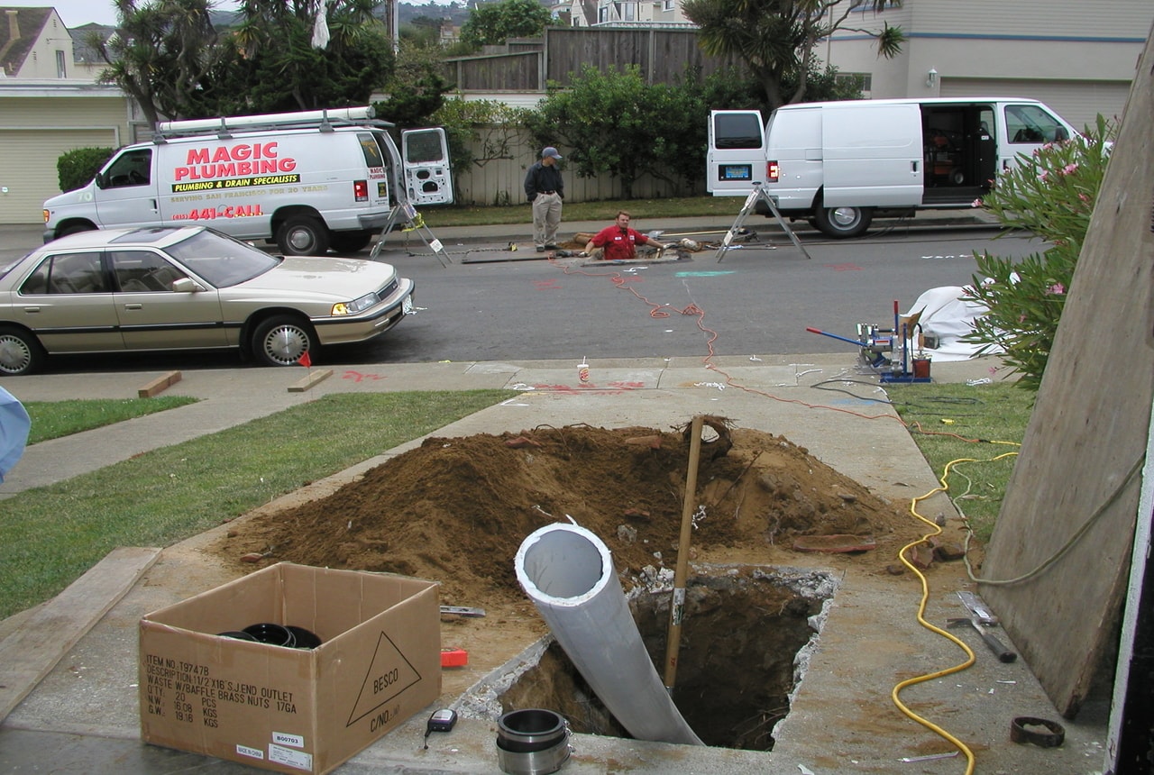 A pipeline coming out of ground near a street