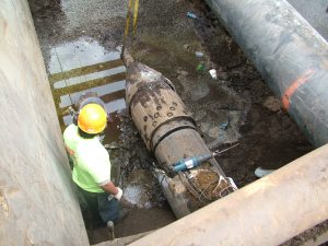 Some workers working at underground pipeline