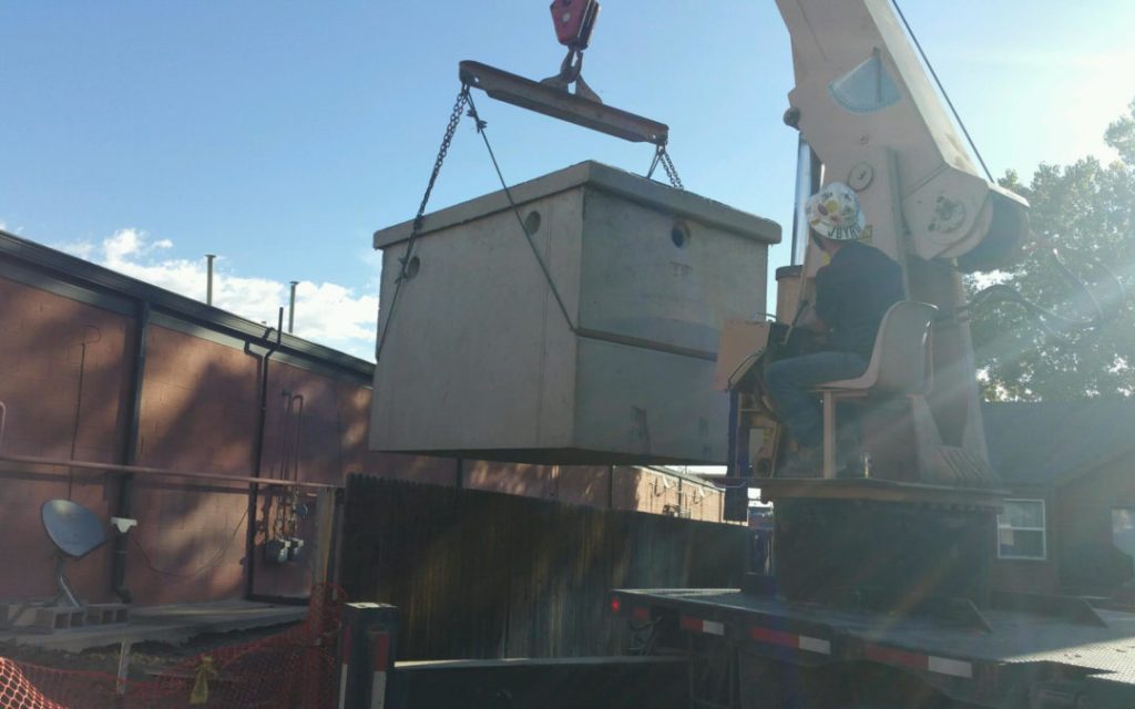 A man installing Grease trap view