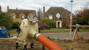 View of an equipment with orange pipe on the sand