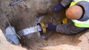 A man looking into the root cause of the sewer line